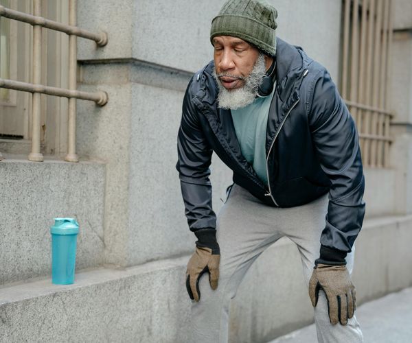 Three silhouettes showing stages of a workout: warmup, main exercise, and cooldown stretch.